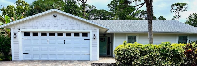 single story home featuring decorative driveway and an attached garage