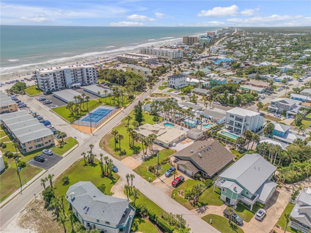 drone / aerial view featuring a view of the beach and a water view