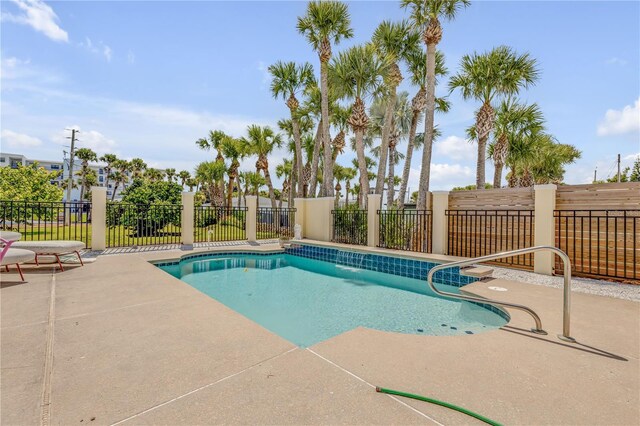 view of swimming pool featuring a fenced in pool, a patio area, and fence