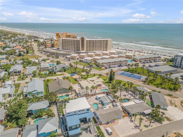 aerial view with a water view and a beach view