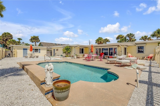 view of pool with a patio area, fence, and a fenced in pool