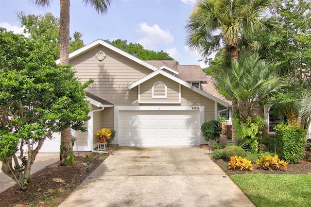 traditional-style home featuring driveway and an attached garage