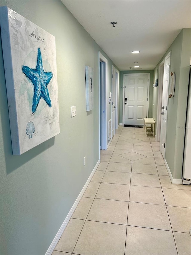 hall featuring light tile patterned flooring