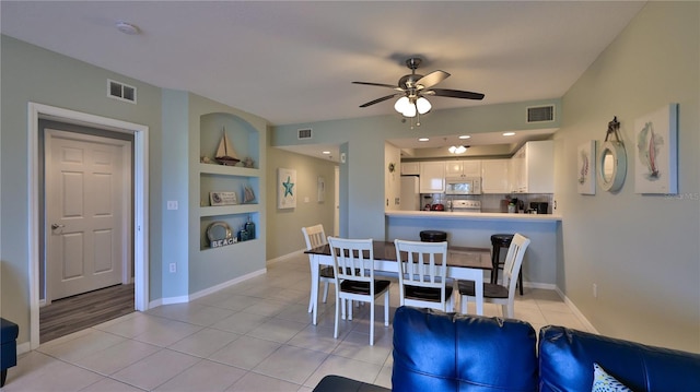 dining area with light tile patterned flooring, built in features, and ceiling fan