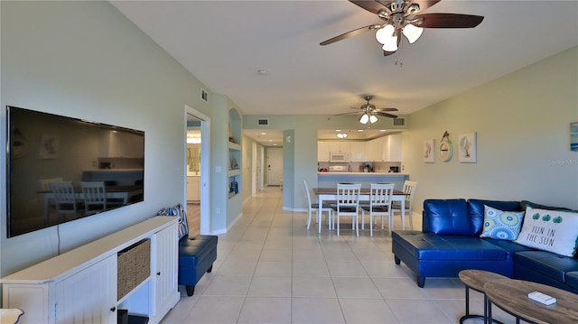 living room with ceiling fan and light tile patterned floors