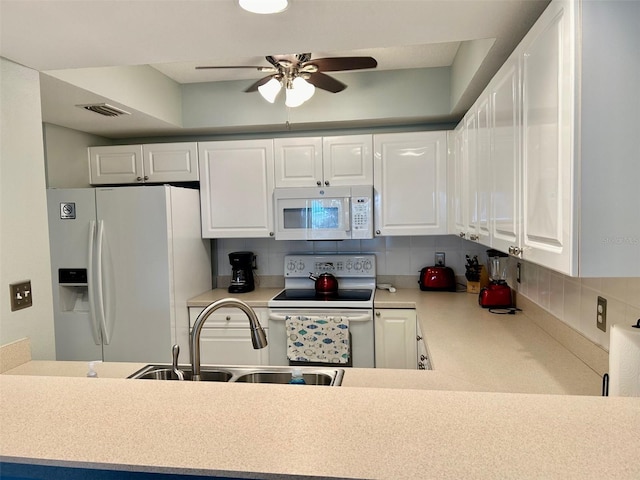 kitchen with ceiling fan, white cabinetry, tasteful backsplash, and white appliances