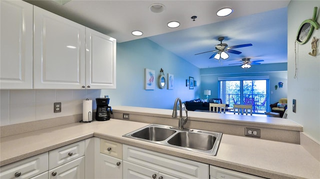 kitchen featuring sink, ceiling fan, white cabinets, and tasteful backsplash