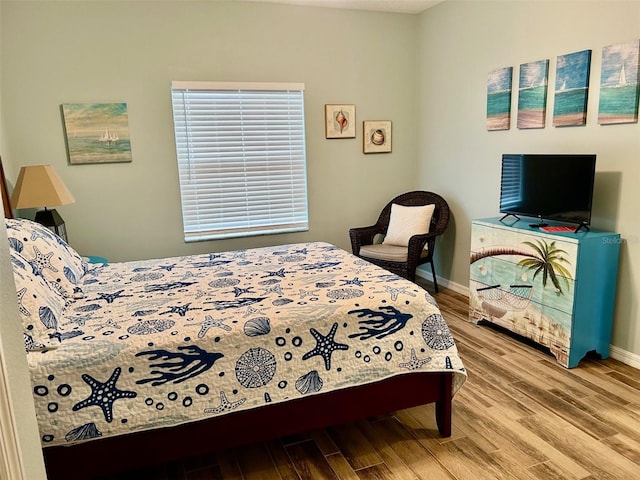 bedroom with hardwood / wood-style flooring