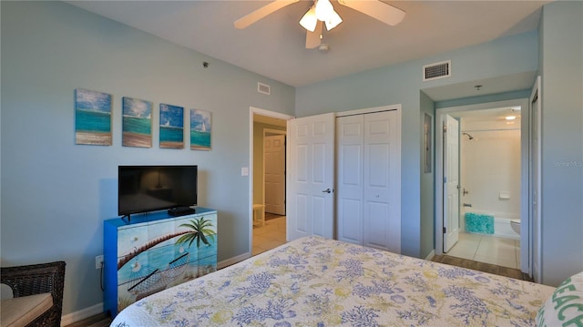 tiled bedroom featuring connected bathroom, a closet, and ceiling fan