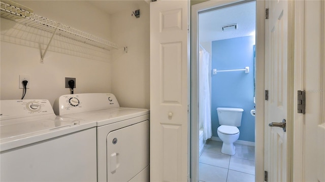 laundry room featuring light tile patterned flooring and independent washer and dryer