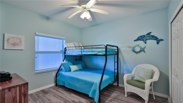 bedroom with a closet, ceiling fan, and hardwood / wood-style floors