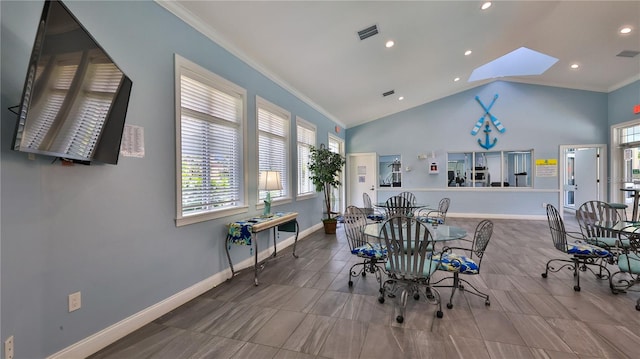 dining area with a skylight, tile patterned floors, crown molding, and high vaulted ceiling