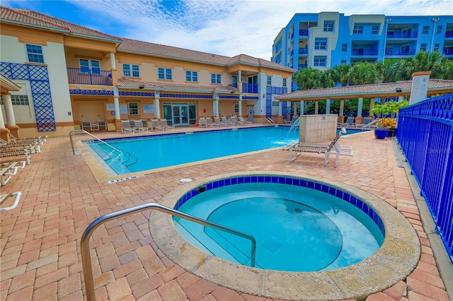 view of pool featuring a patio and a community hot tub