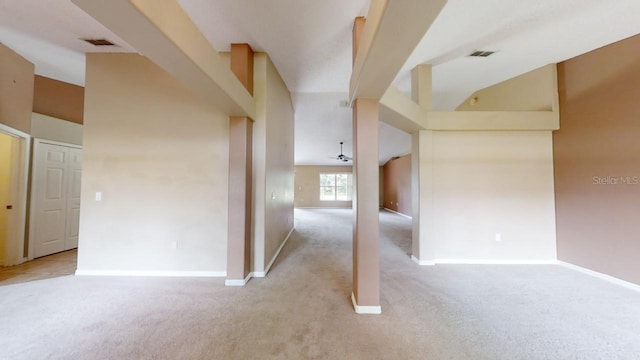 hallway featuring light colored carpet and a high ceiling