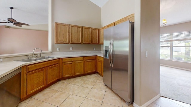 kitchen featuring high vaulted ceiling, sink, light tile patterned floors, ceiling fan, and stainless steel appliances