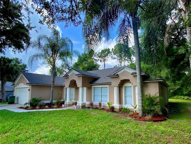 ranch-style home featuring stucco siding, an attached garage, concrete driveway, and a front yard