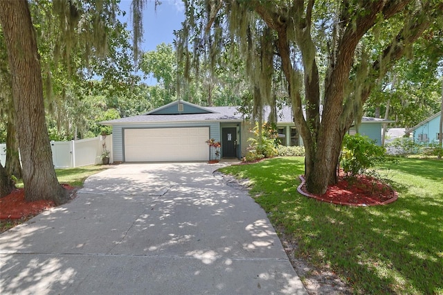 single story home with a garage and a front yard