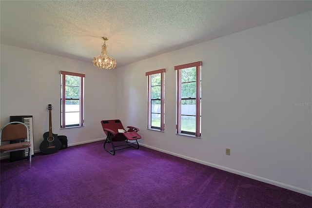 living area with dark colored carpet, a healthy amount of sunlight, and a textured ceiling