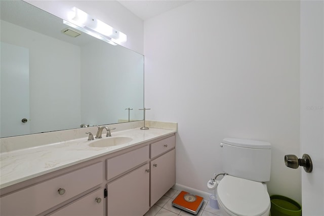 bathroom featuring vanity, tile patterned floors, and toilet