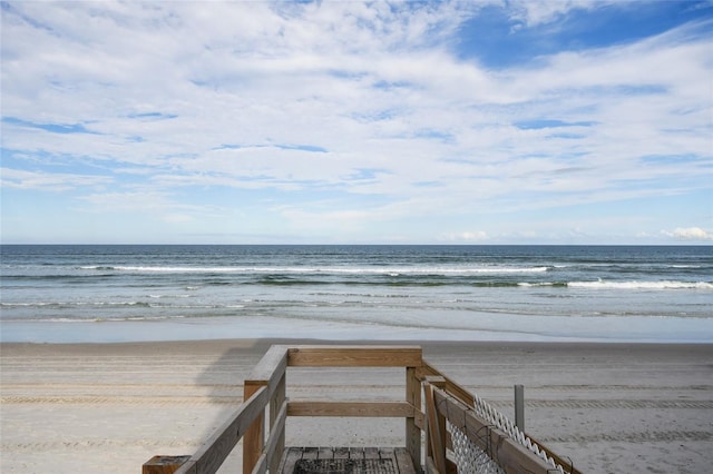 view of home's community with a water view and a view of the beach