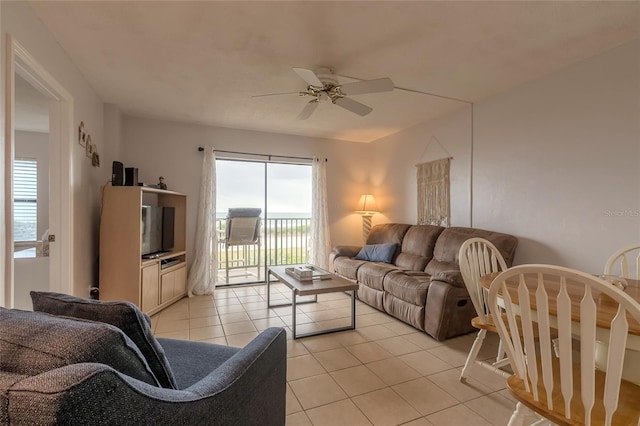 living room featuring light tile patterned flooring and ceiling fan