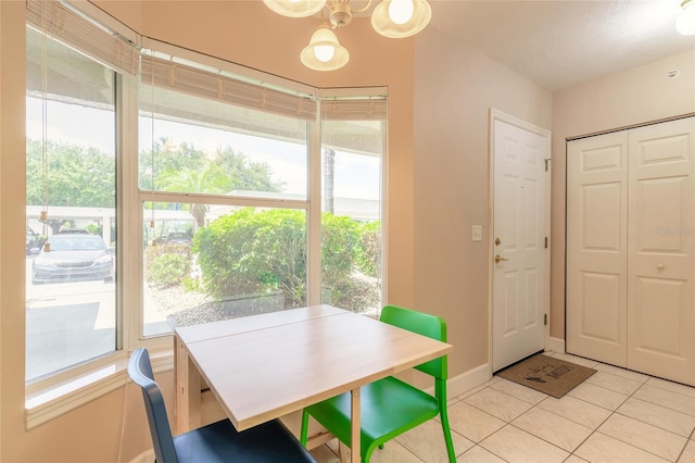 tiled dining area with a chandelier