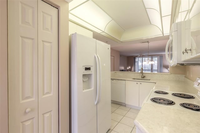 kitchen with sink, white appliances, and white cabinetry