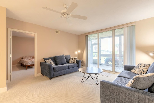 carpeted living room featuring ceiling fan