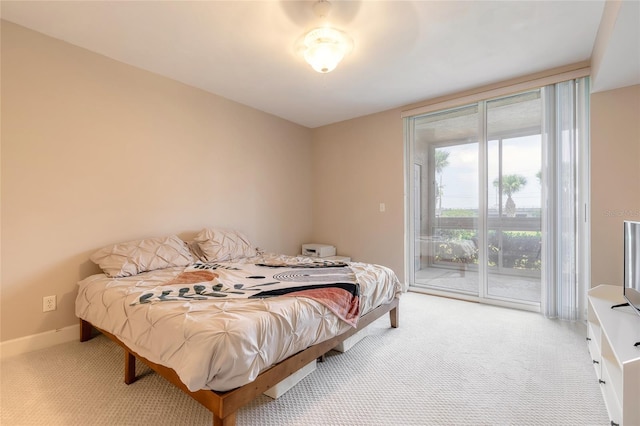 bedroom featuring light carpet, access to outside, and baseboards