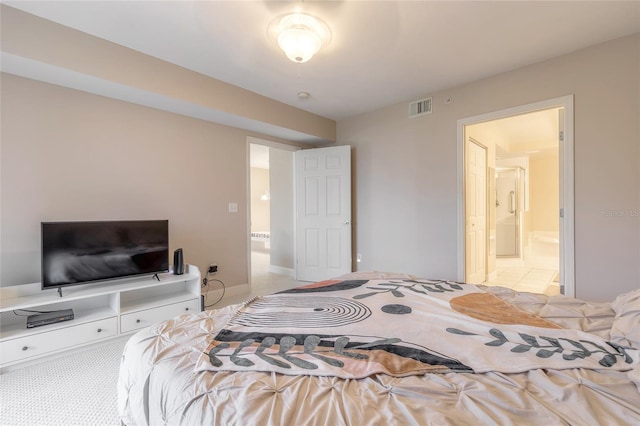 bedroom with ensuite bath and light colored carpet