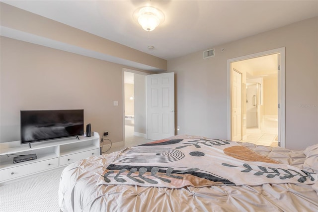 bedroom featuring visible vents, connected bathroom, and light carpet