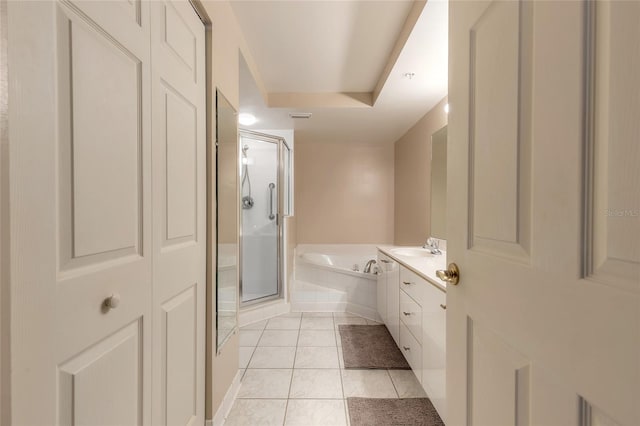 bathroom with vanity, separate shower and tub, tile patterned flooring, and a raised ceiling