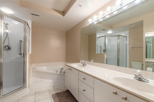 full bathroom featuring independent shower and bath, toilet, tile patterned flooring, and dual bowl vanity