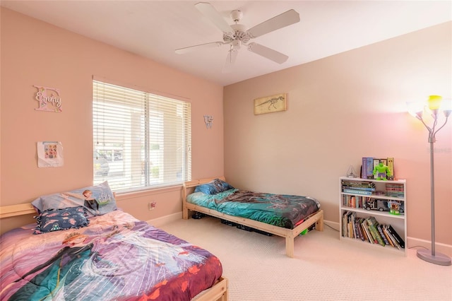 bedroom with ceiling fan, carpet flooring, and baseboards