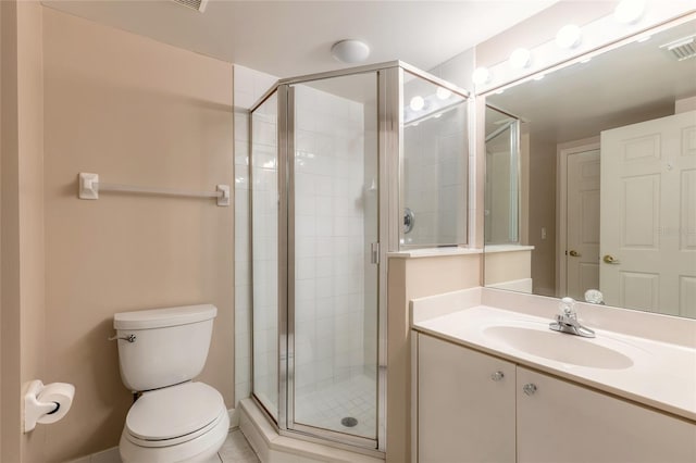 bathroom featuring tile patterned floors, toilet, vanity, and an enclosed shower