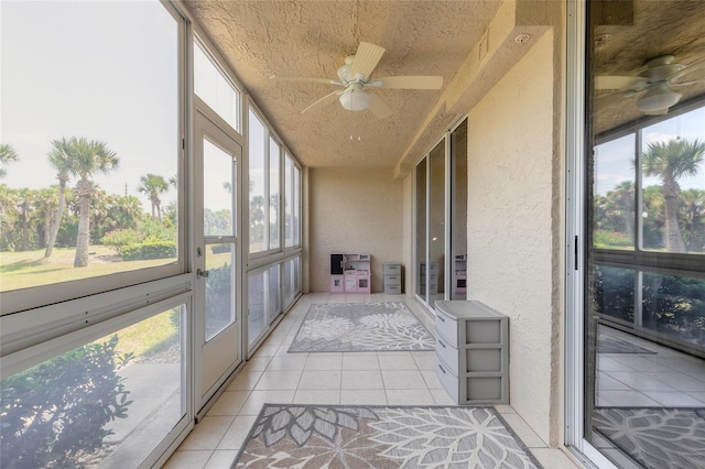 sunroom featuring ceiling fan