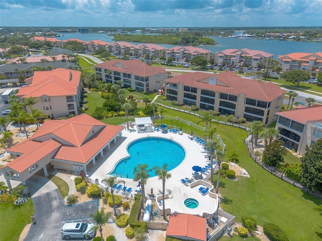 drone / aerial view featuring a water view and a residential view