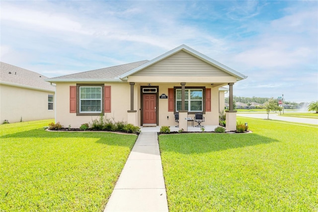 view of front of house with a front lawn and covered porch