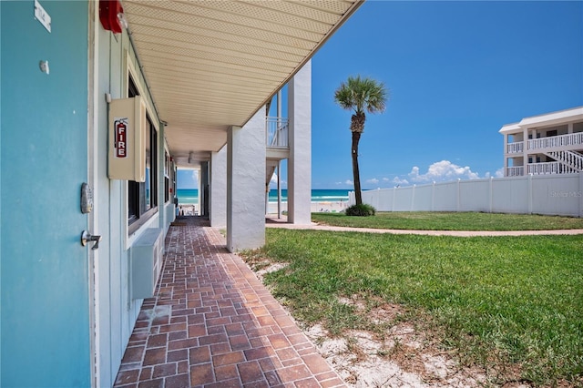 view of yard featuring a water view and fence