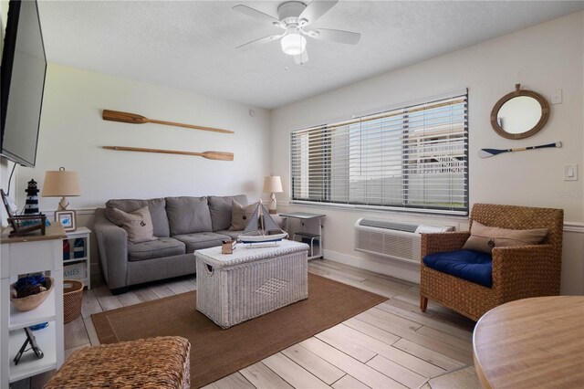 living room featuring light hardwood / wood-style floors and ceiling fan