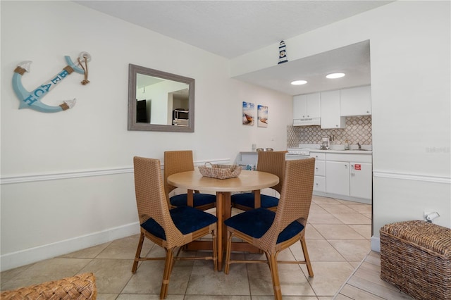 tiled dining space featuring sink