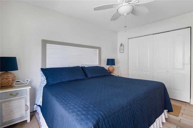 bedroom featuring ceiling fan, light hardwood / wood-style floors, and a closet