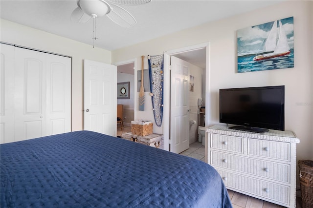 tiled bedroom with a closet, ensuite bath, and ceiling fan