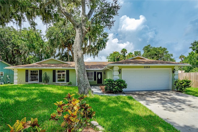 ranch-style house with a garage and a front lawn