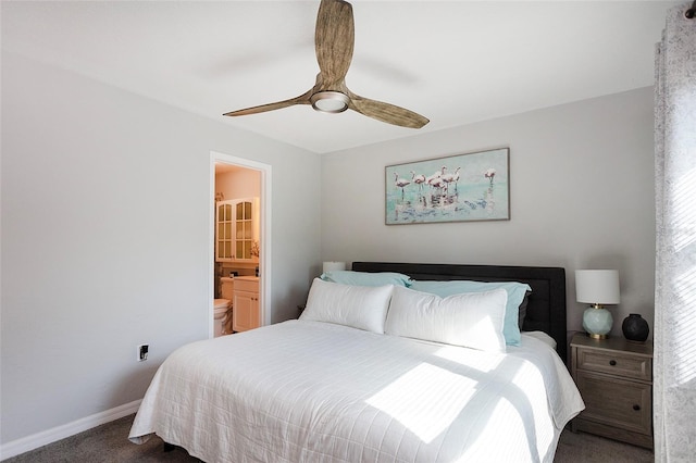 bedroom with ceiling fan, ensuite bathroom, and carpet flooring