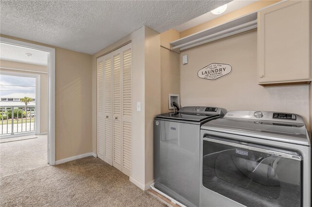 washroom featuring cabinets, independent washer and dryer, a textured ceiling, and light colored carpet