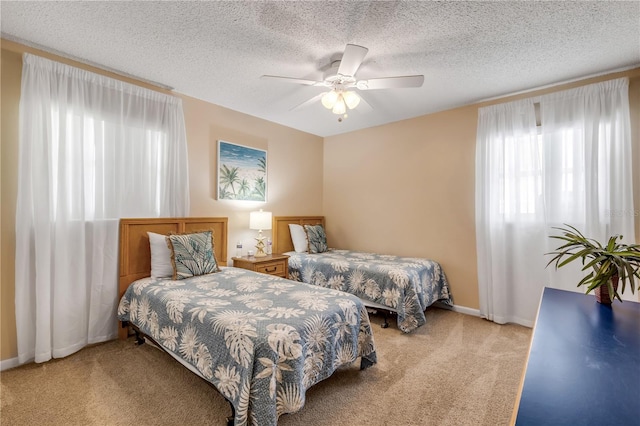 carpeted bedroom featuring a textured ceiling and ceiling fan