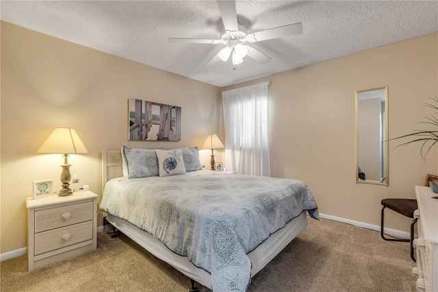 carpeted bedroom with ceiling fan and a textured ceiling