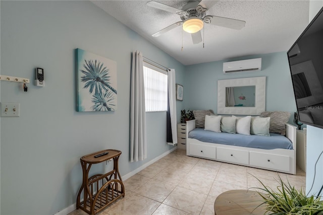 interior space with an AC wall unit, ceiling fan, and a textured ceiling