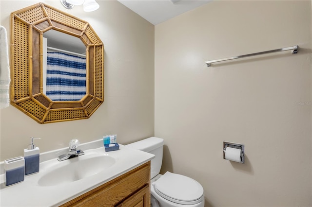 bathroom featuring vanity and toilet